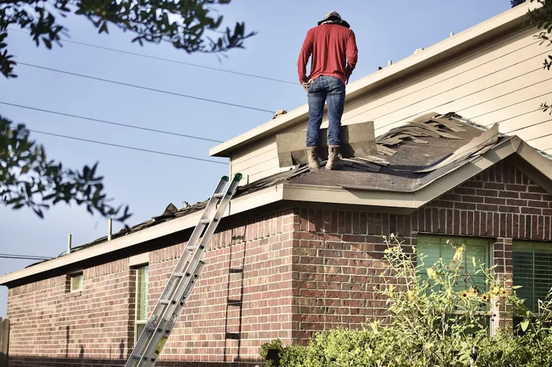 Professional roofer working on a residential roof in Dicktown
